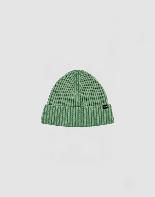 The LIVE FAST DIE YOUNG Washed Rib Knit Beanie in green, made of cotton with a folded cuff and a small black side tag, is shown against a plain white background.