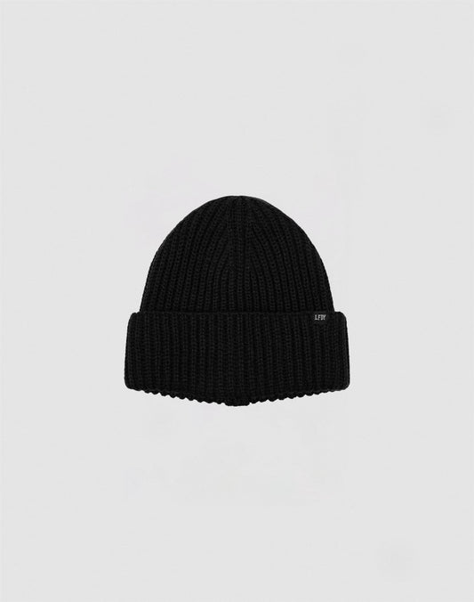 A black Rib Knit Beanie by LIVE FAST DIE YOUNG, made from soft Polyacryl with a folded brim, is centered on a plain light gray background.