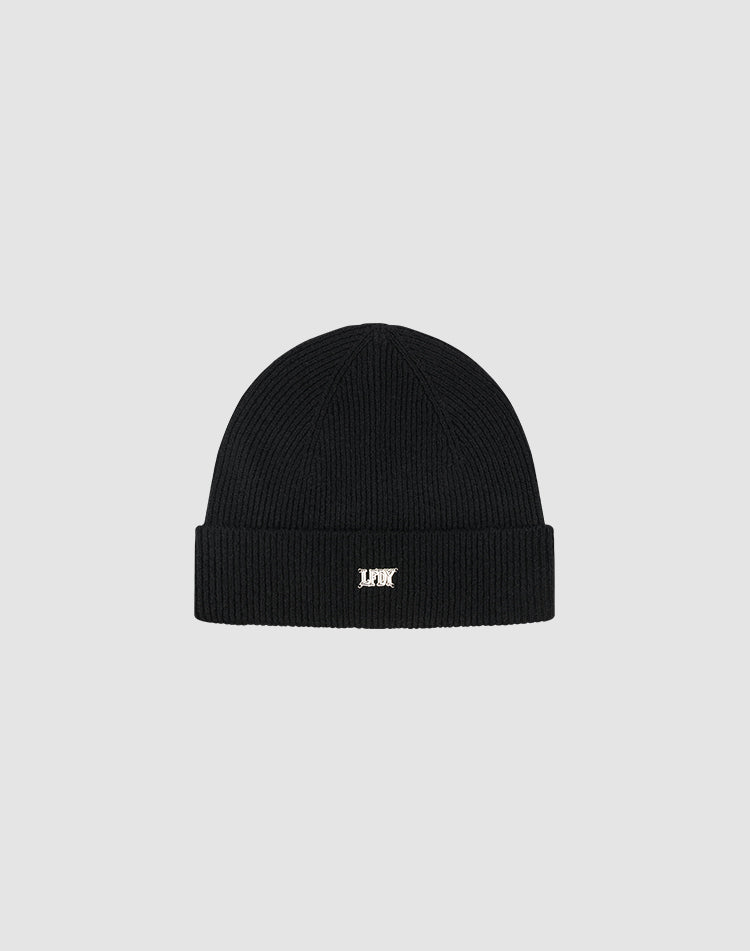 The Live Fast Boucle Beanie by LIVE FAST DIE YOUNG is a black polyester knit, one size, with a folded brim and a small white embroidered logo on the front, shown against a plain light gray background.| plain 