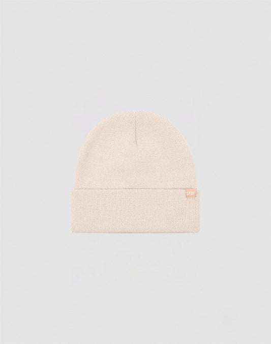 The LIVE FAST DIE YOUNG Basic Beanie is a plain, light beige polyacryl hat with a folded brim and a small flaglabel tag on the side, shown against a light gray background.