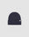 The LIVE FAST DIE YOUNG Basic Beanie is a plain dark navy blue knit, One Size, with a folded brim and a small white Flaglabel tag on the front, displayed against a light gray background.