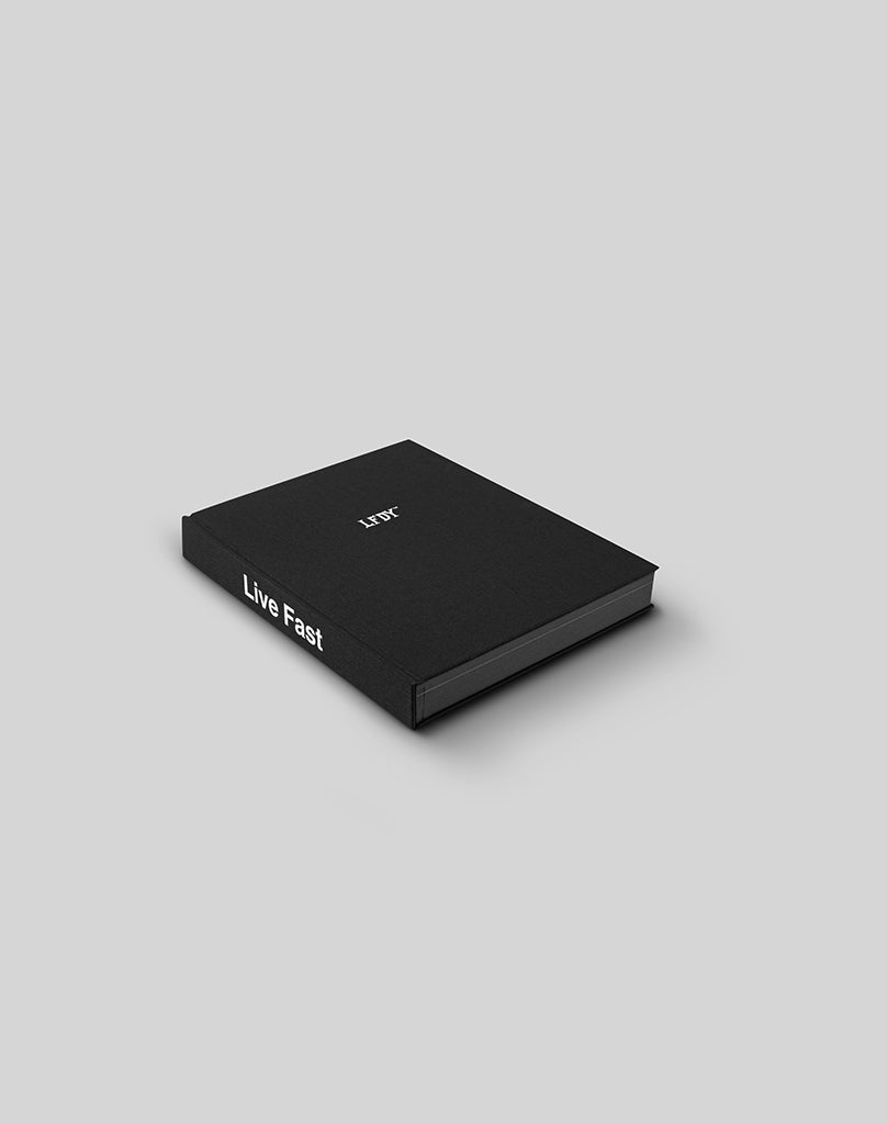 A black hardcover LFDY Brand Bible by LIVE FAST DIE YOUNG, featuring Live Fast in white on the spine and minimal cover text, placed on a plain light gray background. 