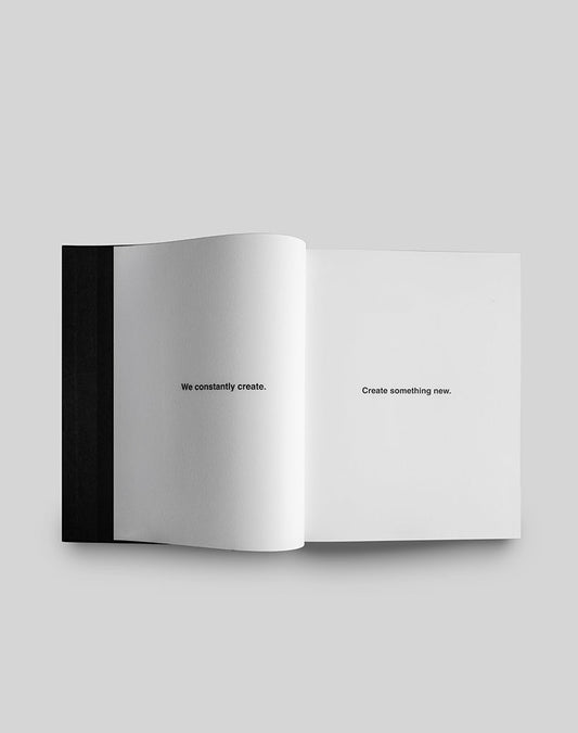 The LFDY Brand Bible by LIVE FAST DIE YOUNG is shown open on a light gray background, with white pages, a black spine, and centered minimalist text: “We constantly create” on the left, and “Create something new” on the right.