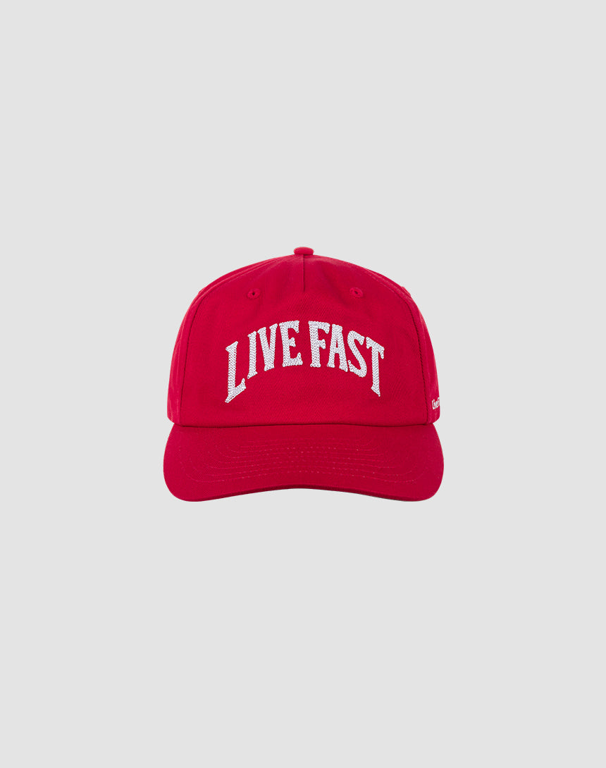 The Live Fast Unstructured Cap by LIVE FAST DIE YOUNG features bold white LIVE FAST text and a Logo-Stick on a red cap with Mit Snapverschluss for easy adjustment. Photographed against a plain light gray background. One size fits most.