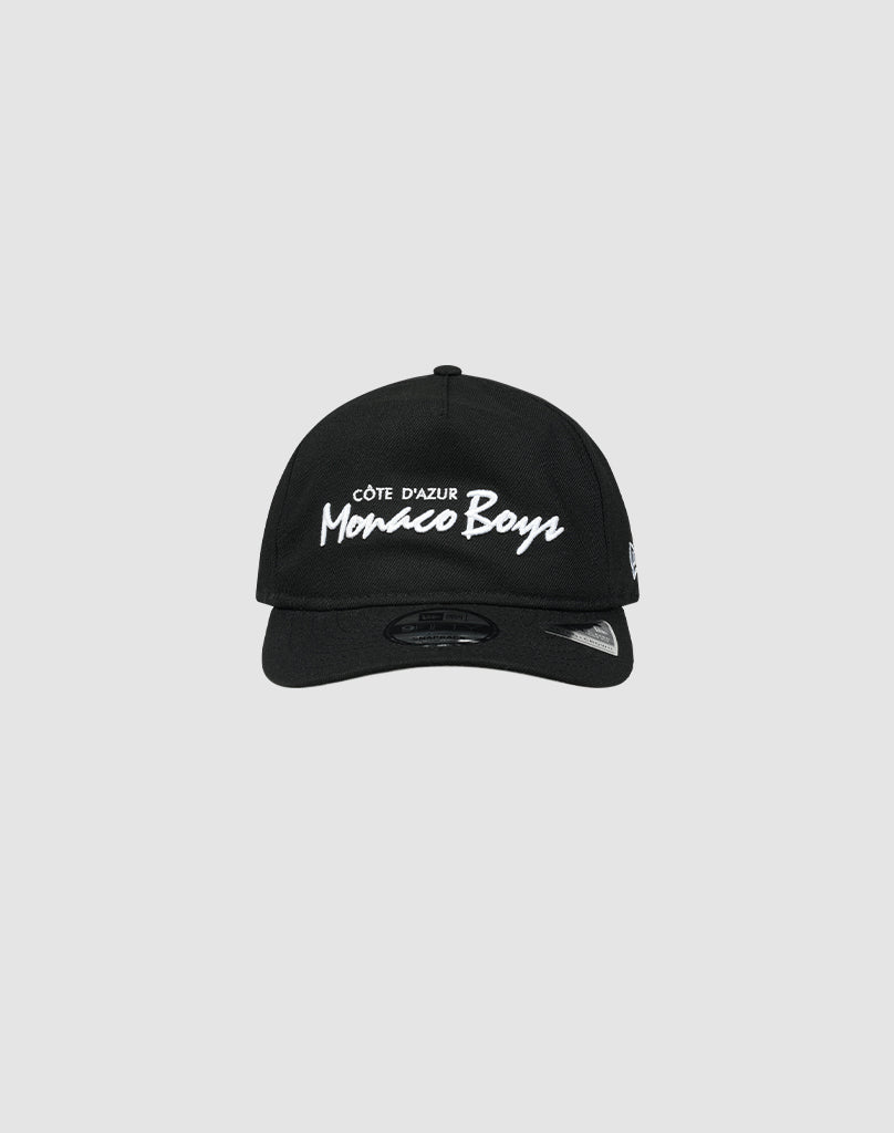 The LFDY X NEW ERA Monaco Boys cap by LIVE FAST DIE YOUNG is a black Retro Crown baseball cap featuring white Côte dAzur Monaco Boys embroidery on the front, shown against a plain light gray background.