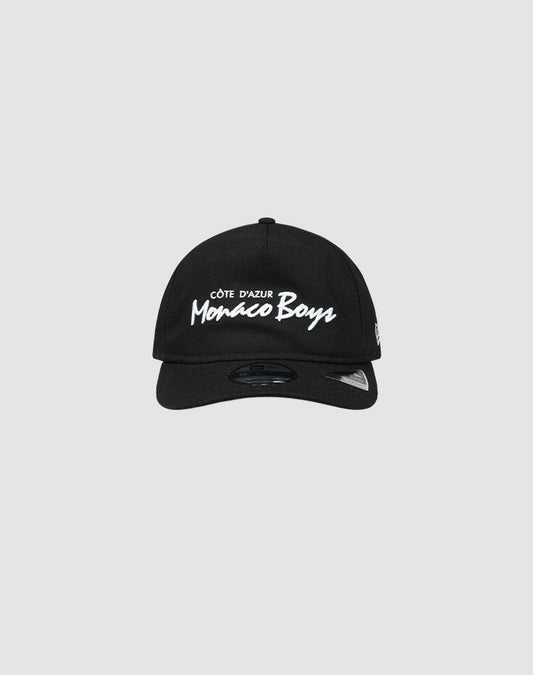 The LFDY X NEW ERA Monaco Boys cap by LIVE FAST DIE YOUNG is a black Retro Crown baseball cap featuring white Côte dAzur Monaco Boys embroidery on the front, shown against a plain light gray background.