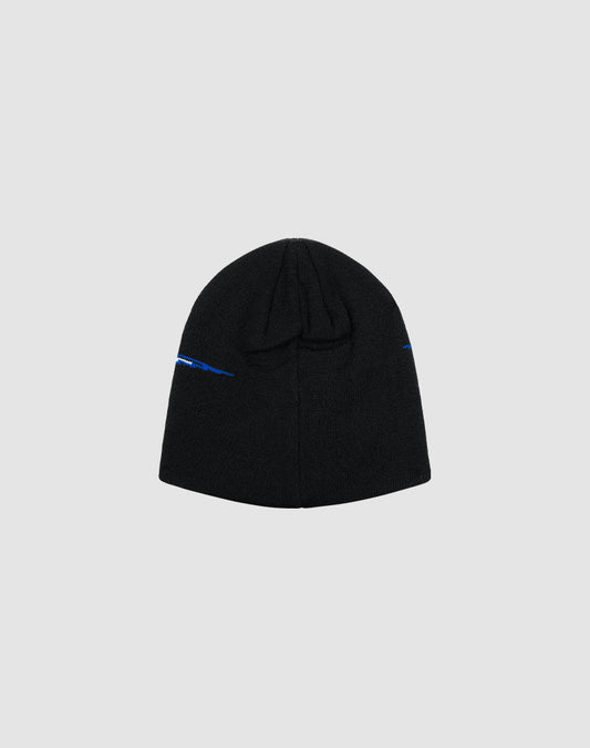 The LIVE FAST DIE YOUNG Live Fast 3000 Beanie is a black knit hat made from soft Polyacryl, with a small blue Logo-Strick detail near the edge, shown flat on a light gray background.