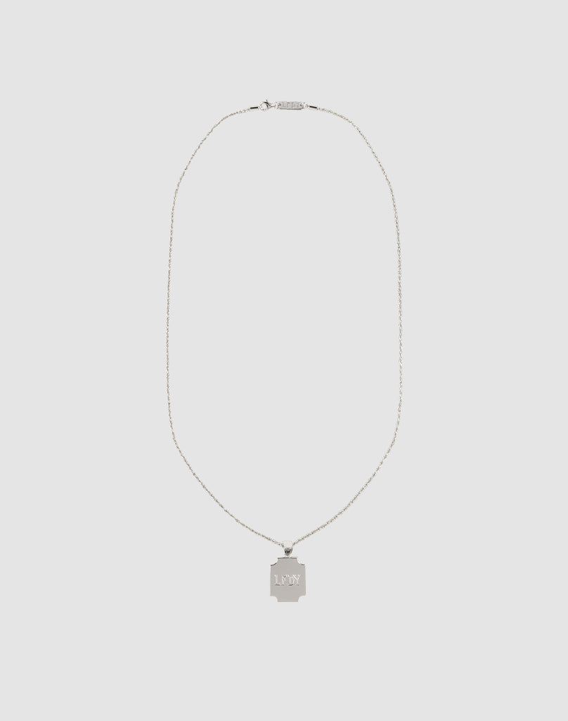 The LFDY Monaco Boys Plate Chain by LIVE FAST DIE YOUNG features a delicate sterling silver chain and a square pendant engraved with L*MY, showcased against a plain light gray background.