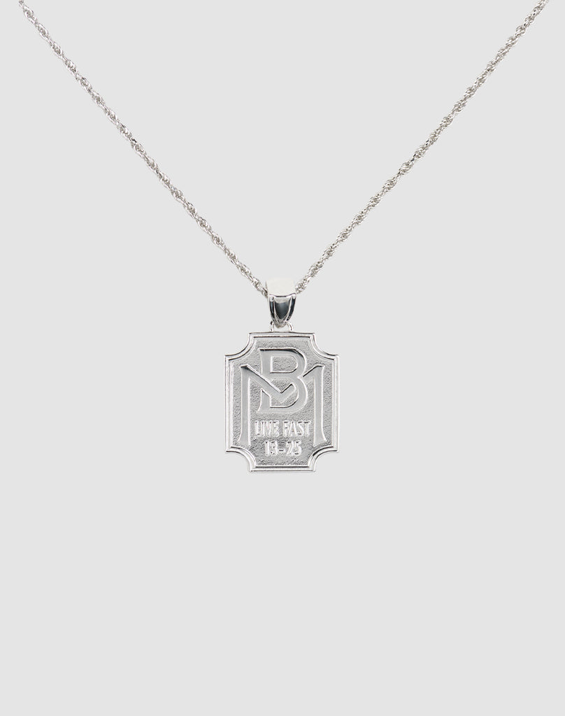 The LFDY Monaco Boys Plate Chain by LIVE FAST DIE YOUNG features an engraved rectangular pendant on a delicate, twisted sterling silver chain, displayed against a plain light background.