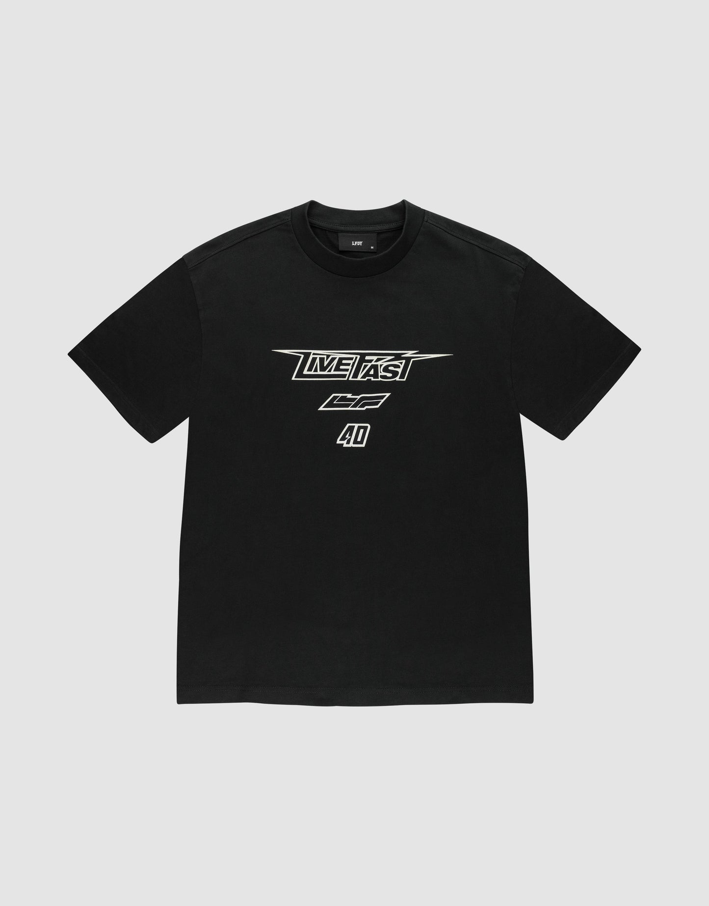 The LFDY Triple Racing Tee by LIVE FAST DIE YOUNG is a black oversized short-sleeve t-shirt with bold white multilogo frontprint—LIVE FAST, CF, and 4D—in a racing-inspired font. Made from 100% Baumwolle and shown on a light grey background.