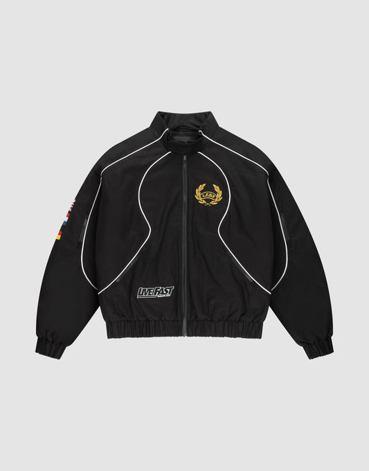 The LFDY Canvas Jacket by LIVE FAST DIE YOUNG is a black regular-fit zip-up with white piping, gold crest on the left chest, flag patches on the right sleeve, Multilogo Stickereien, and a "LIVE FAST" text patch near the left pocket. | plain