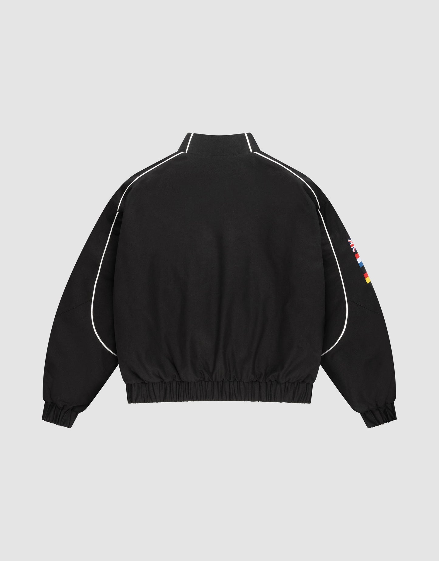 The LFDY Canvas Jacket by LIVE FAST DIE YOUNG is black with white piping on the sleeves and shoulders, multilogo flag patches on the right sleeve, elastic cuffs and hem, displayed on a plain light gray background.