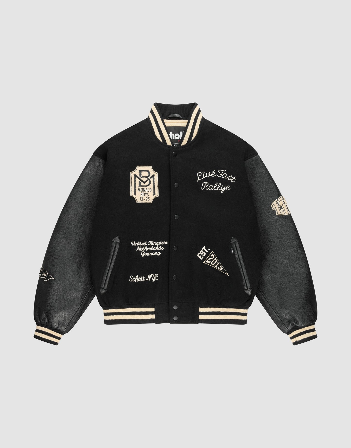 The LIVE FAST DIE YOUNG LFDY x Schott NYC Varsity Jacket is a limited edition black jacket with cream accents, leather sleeves, embroidered patches and text, plus striped cuffs, collar, and hem.