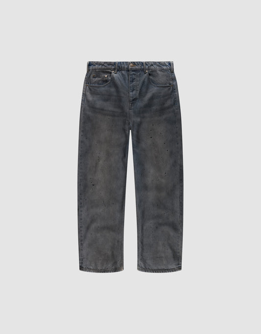 The LFDY Coated Baggy Denim by LIVE FAST DIE YOUNG features wide legs, a baggy fit, faded black 100% Baumwolle fabric, distressed detailing, and subtle paint splatters, shown against a plain white background. | plain