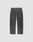 Back view of the LIVE FAST DIE YOUNG LFDY Coated Baggy Denim in faded black, made from 100% Baumwolle, featuring a baggy fit, two back pockets, and subtle paint splatters on a plain light gray background.
