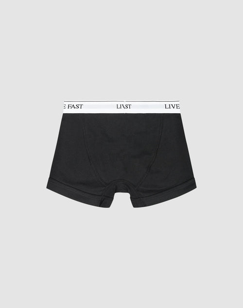LIVE FAST DIE YOUNG Live Fast Trunks (2 Pack): Black regular-fit boxer briefs with a white waistband featuring LIVE FAST in black text, shown on a light gray background.