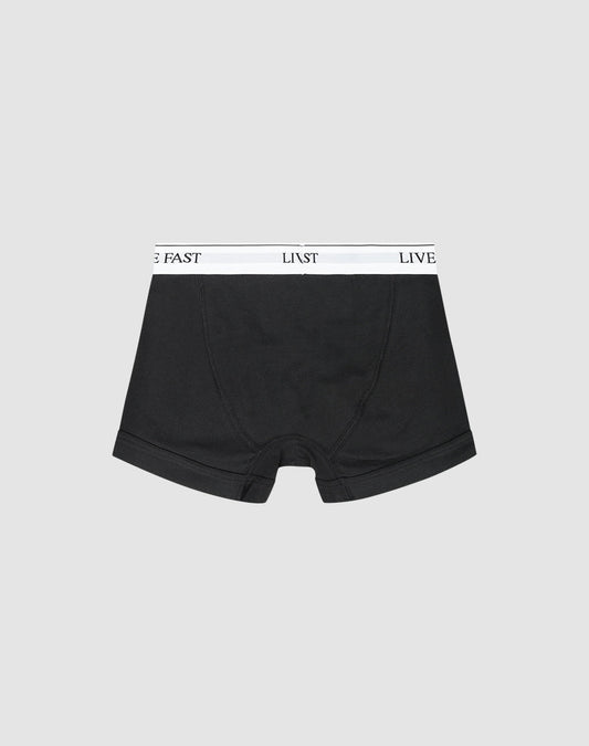 LIVE FAST DIE YOUNG Live Fast Trunks (2 Pack): Black regular-fit boxer briefs with a white waistband featuring LIVE FAST in black text, shown on a light gray background.