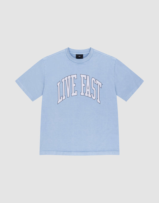 The LIVE FAST DIE YOUNG Live Fast College Tee is a light blue, 100% Baumwolle oversize short-sleeve shirt with "LIVE FAST" in large white arched letters on the front, shown on a plain white background. | plain
