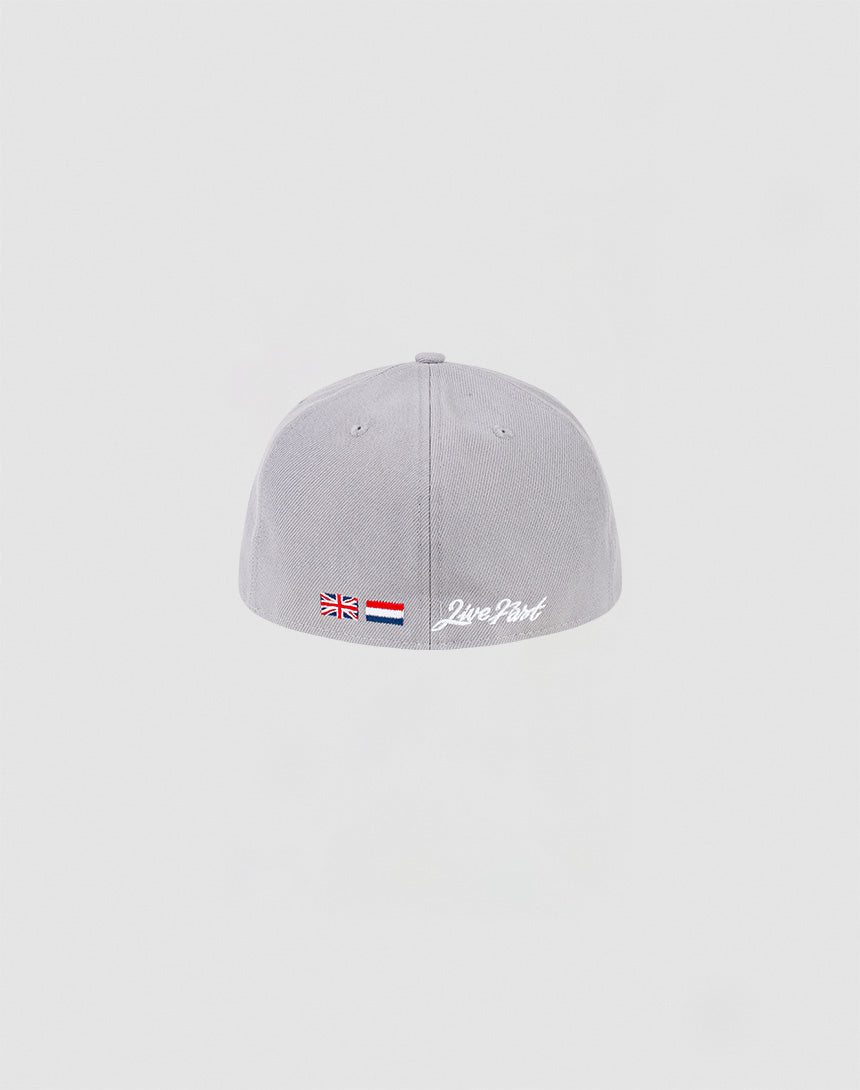 A light grey LFDY x NEW ERA 59FIFTY Low Profile fitted cap by LIVE FAST DIE YOUNG is shown from the back, with small UK and Dutch flags, the Netherlands flag, and Zero Part embroidered in white on a plain light grey background.