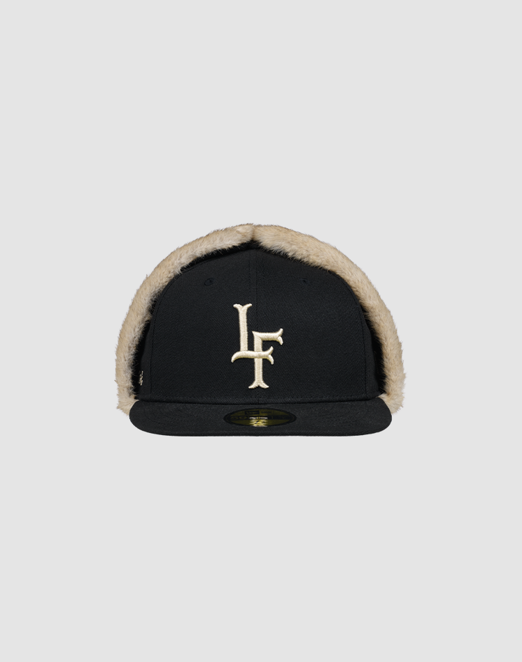 The LFDY x New Era 59Fifty DogEar by LIVE FAST DIE YOUNG features beige faux fur lining and a bold LF Kunstpelz logo on the front. Shown is the fitted cap on a plain gray background.