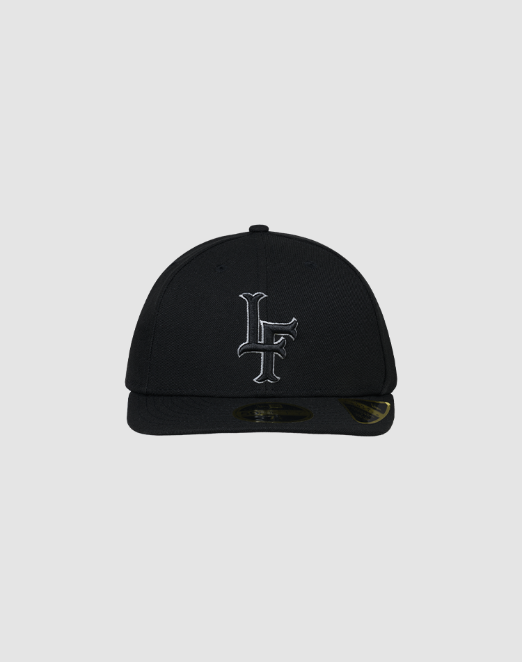 A black LFDY X NEW ERA 59FIFTY Low Profile fitted cap by LIVE FAST DIE YOUNG, featuring a flat brim and white LF initials embroidered on the front, displayed against a plain gray background.| plain 