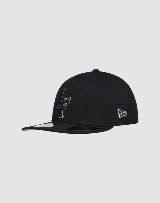 The LFDY X NEW ERA 59FIFTY Low Profile cap by LIVE FAST DIE YOUNG is black with bold white “LF” embroidery on the front and the New Era logo on the side, shown against a plain gray background.