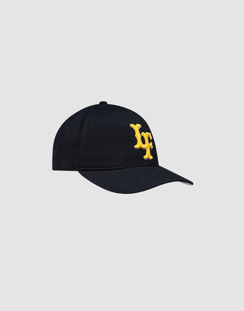 The LFDY Snapback by LIVE FAST DIE YOUNG is a black cap with a curved brim, green underbill, bold yellow LF embroidery on the front, and a snap closure, shown on a plain light grey background.