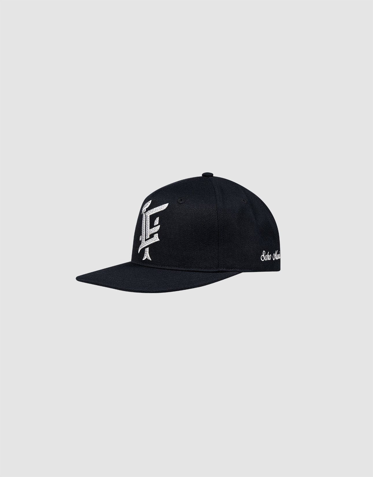 The LF Rhinestone Cap by LIVE FAST DIE YOUNG is a black cotton baseball cap with a flat brim, featuring a white logo embroidery on the front and white script on the side, shown on a plain light gray background.