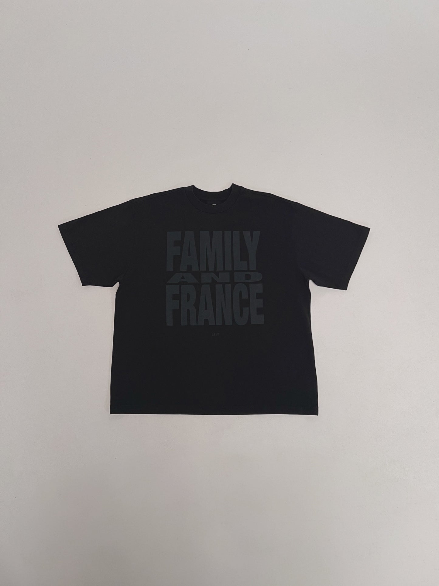 The LFDY Family & France Tee by LIVE FAST DIE YOUNG is a black oversized T-shirt featuring bold "FAMILY AND FRANCE" text across the chest and a subtle flag-label detail.