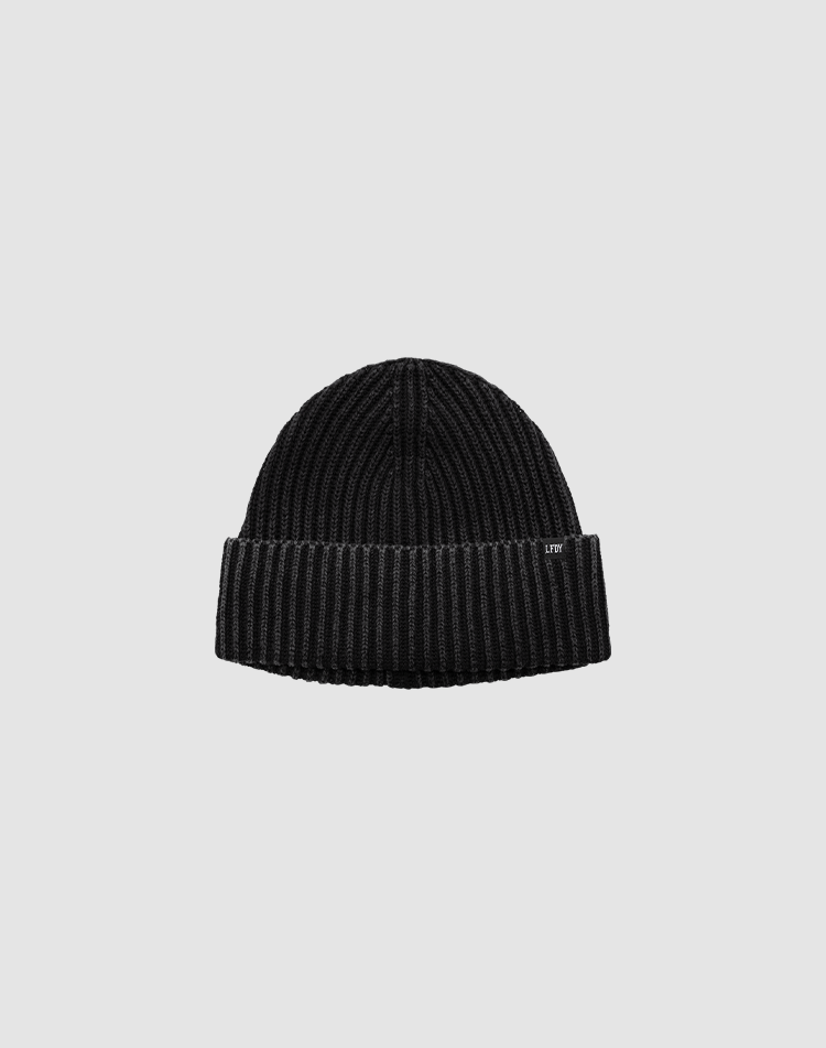 The Washed Rib Knit Beanie by LIVE FAST DIE YOUNG in black Baumwolle features a folded cuff with a small tag, shown on a plain light gray background.