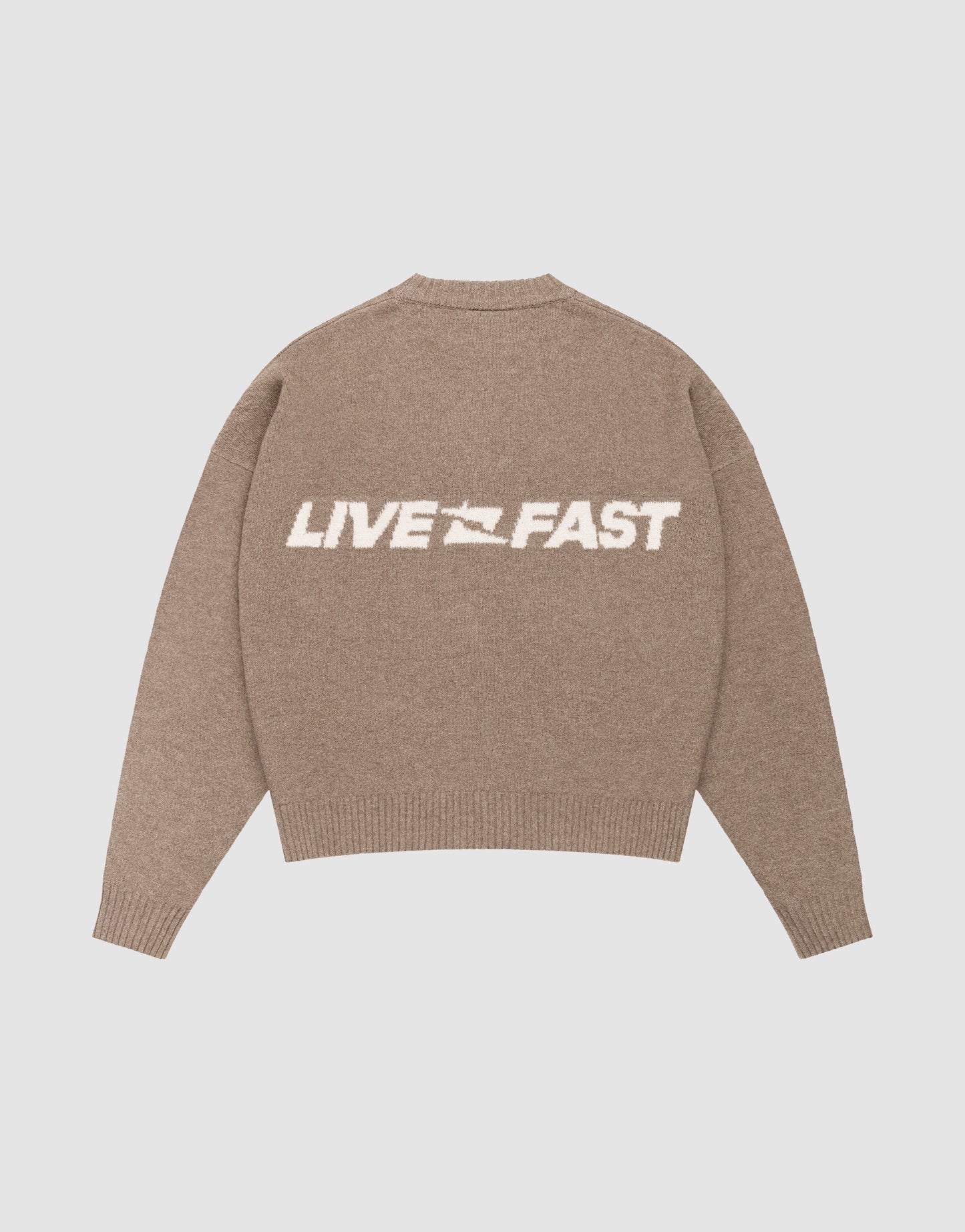 The Live Fast Boucle Sweater by LIVE FAST DIE YOUNG is an oversized beige knit with "LIVE FAST" in bold white letters and a small white flag icon on the back.