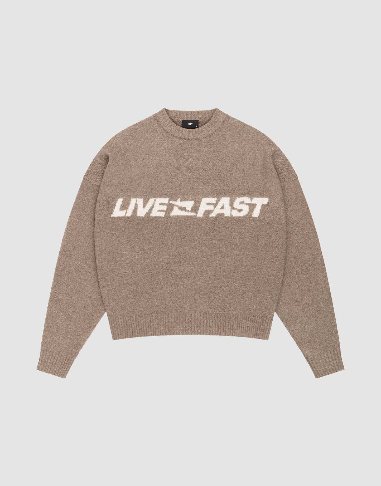 The Live Fast Boucle Sweater by LIVE FAST DIE YOUNG is a beige, oversize fit knit with long sleeves and ribbed trims. "LIVE FAST" in bold white and a speeding car graphic feature on the front for standout style.