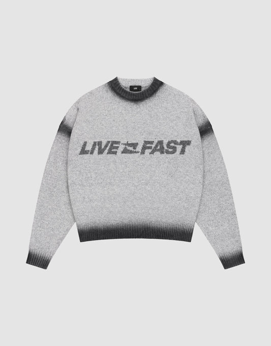 The Live Fast Boucle Sweater by LIVE FAST DIE YOUNG features a gray design with black cuffs, collar, and hem, bold “LIVE FAST” lettering across the front, and an oversize fit for a relaxed look. | plain