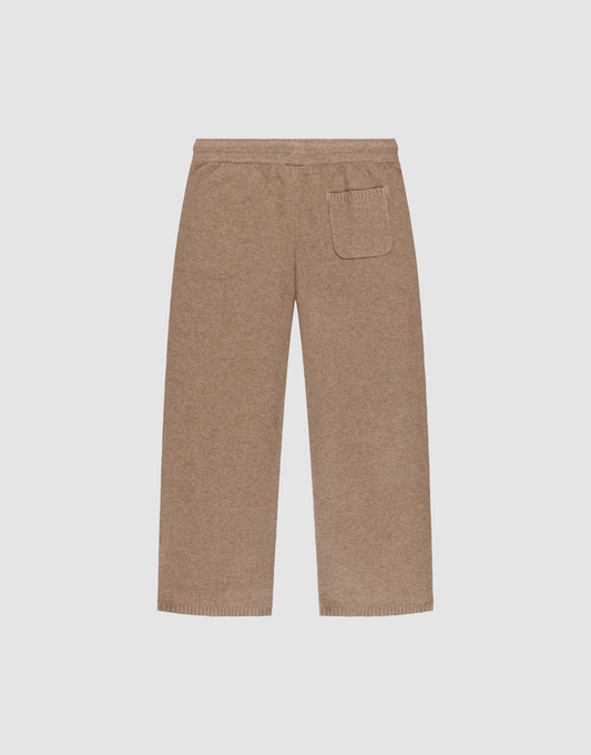 The Live Fast Boucle Pants by LIVE FAST DIE YOUNG are beige, wide-leg knit pants with an elastic waistband, straight leg, and a single back patch pocket, shown flat on a white background.