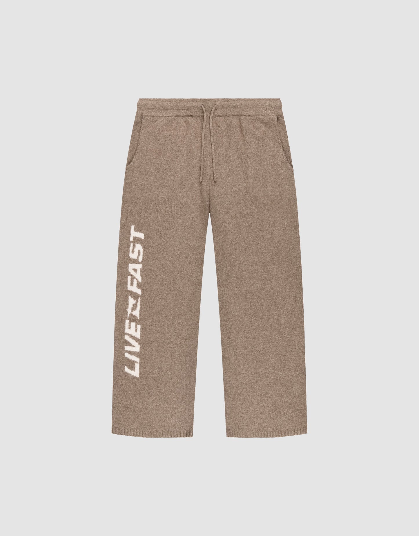 The Live Fast Boucle Pants by LIVE FAST DIE YOUNG are brown wide-leg sweatpants with a wide fit, elastic waistband (Elastikbund), drawstring, side pockets, and "LIVE FAST" boldly printed in white down the left leg.