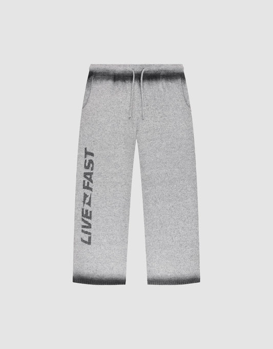 LIVE FAST DIE YOUNG’s Live Fast Boucle Pants: light gray, wide fit with straight leg, dark gray gradient waistband/cuffs, drawstring elastic waist, side pockets, and bold black LIVE FAST print down the left leg. | plain