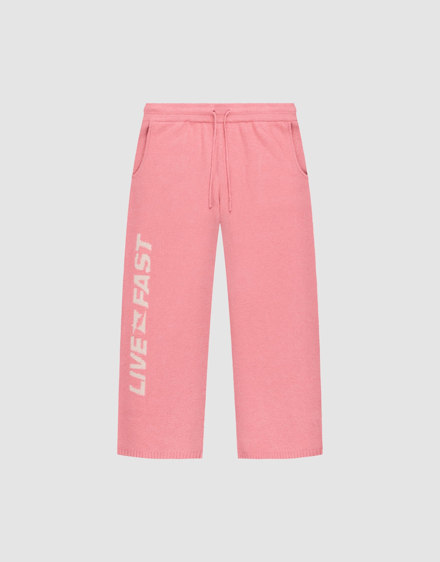 The Live Fast Boucle Pants by LIVE FAST DIE YOUNG feature a wide fit, elastic waistband with drawstring, side pockets, and "LIVE FAST" in white on the left leg—ideal for a relaxed look with a trendy straight-leg silhouette.