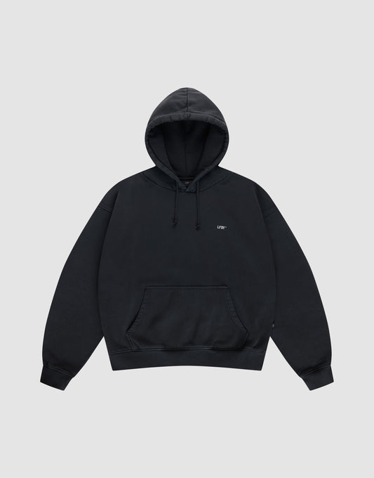 The Live Fast Vegas Hooded by LIVE FAST DIE YOUNG is a plain black oversized hoodie with a hood, front pocket, drawstrings, and small white text on the left chest, shown on a light gray background.