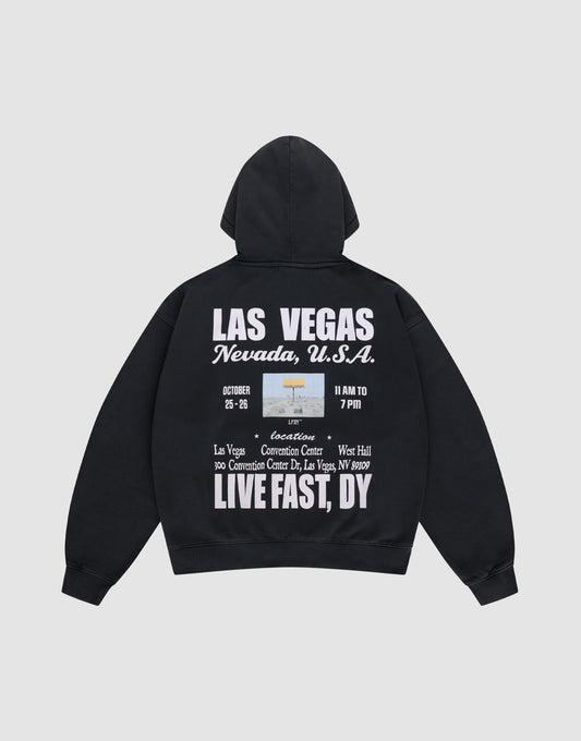 The Live Fast Vegas Hooded by LIVE FAST DIE YOUNG is a black oversize-fit hoodie with a cozy hood, front and back prints, bold white "LAS VEGAS Nevada, U.S.A." text, event details, and phrases like LIVE FAST, DY, and Convention Center. | plain