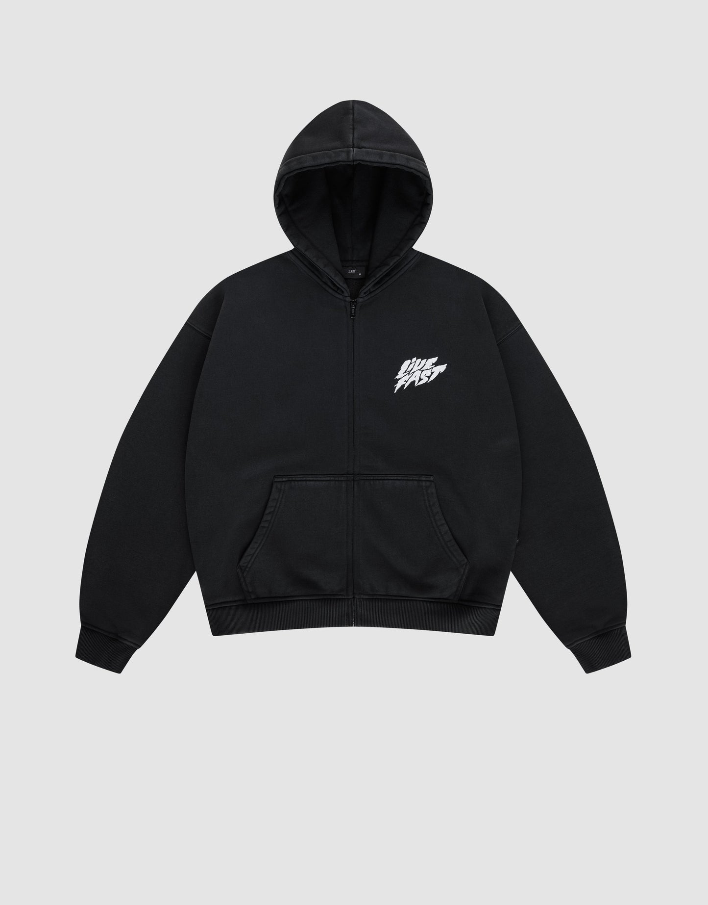 The LFDY Logo Hooded Zip by LIVE FAST DIE YOUNG is a black Oversize Fit zip-up hoodie with a front pocket and white LIVE FAST graphic on the chest, made from soft Baumwolle, shown against a plain light gray background.