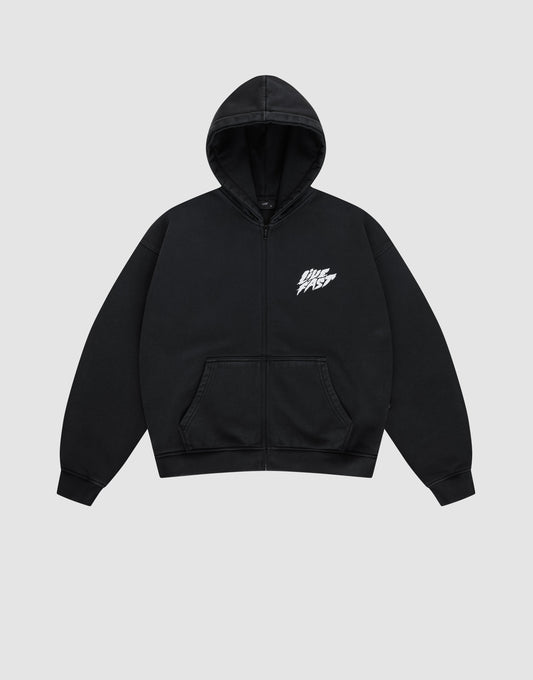 The LFDY Logo Hooded Zip by LIVE FAST DIE YOUNG is a black Oversize Fit zip-up hoodie with a front pocket and white LIVE FAST graphic on the chest, made from soft Baumwolle, shown against a plain light gray background.