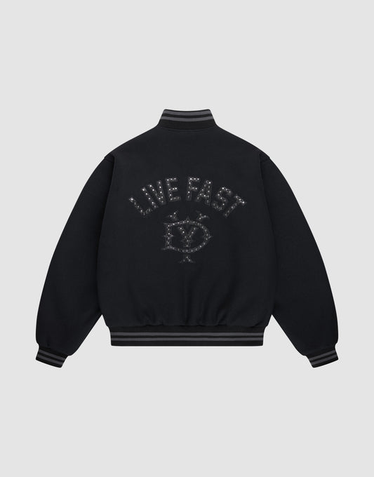The Live Fast College Jacket by LIVE FAST DIE YOUNG is a black varsity jacket with striped cuffs and hem, a metal zipper, and an embroidered eye with stars and "LIVE FAST" on the back in dark thread. The background is light gray. | plain