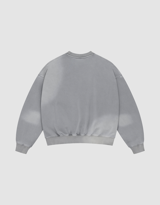 The Basic LiveFast Sweater by LIVE FAST DIE YOUNG is a light gray, oversized crewneck displayed flat with the back up. It features a subtle faded effect, long sleeves, ribbed cuffs and hem for a classic look.