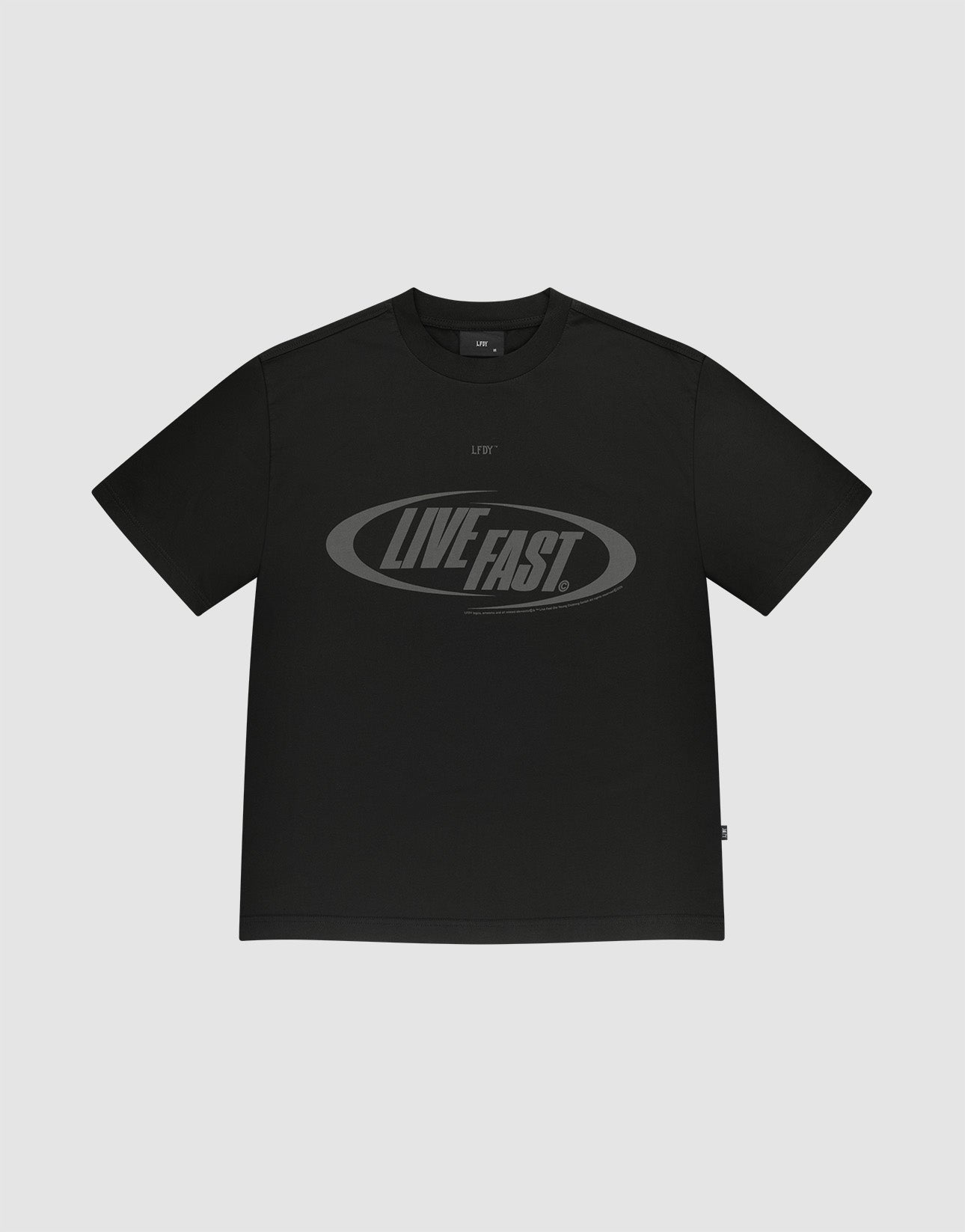 The LFDY Sphere Tee by LIVE FAST DIE YOUNG is a black oversized short-sleeve t-shirt made from 100% Baumwolle, featuring bold "LIVE FAST" text in a large oval graphic with a dark, slightly shiny design on light gray. | plain