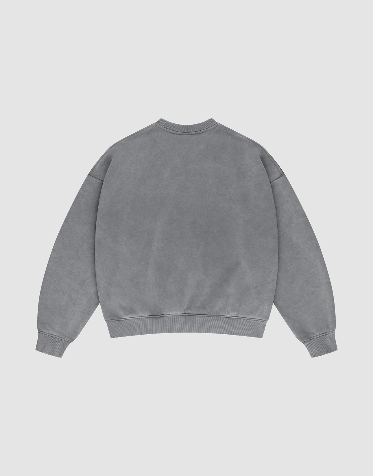 The LIVE FAST DIE YOUNG Basic Chest Sweater, an oversized gray crewneck in Oversize Fit made from cotton, is laid flat on a light gray background, displaying its back with long sleeves, ribbed cuffs, and waistband.