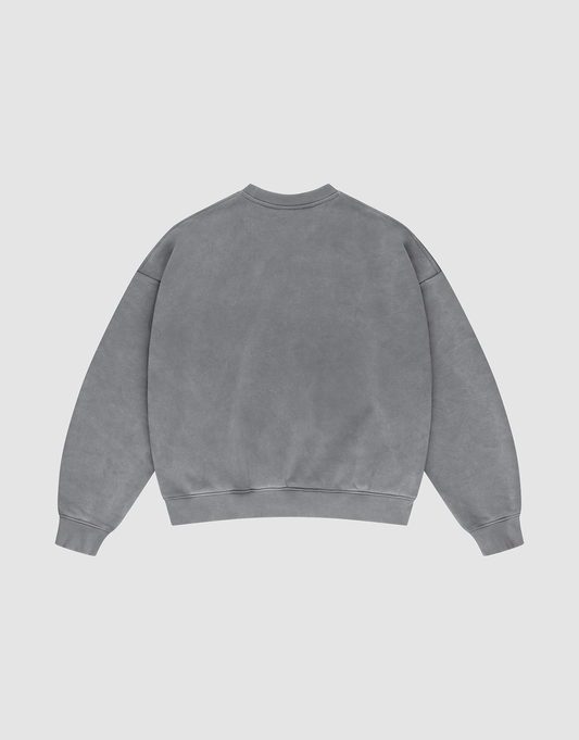 The LIVE FAST DIE YOUNG Basic Chest Sweater, an oversized gray crewneck in Oversize Fit made from cotton, is laid flat on a light gray background, displaying its back with long sleeves, ribbed cuffs, and waistband.
