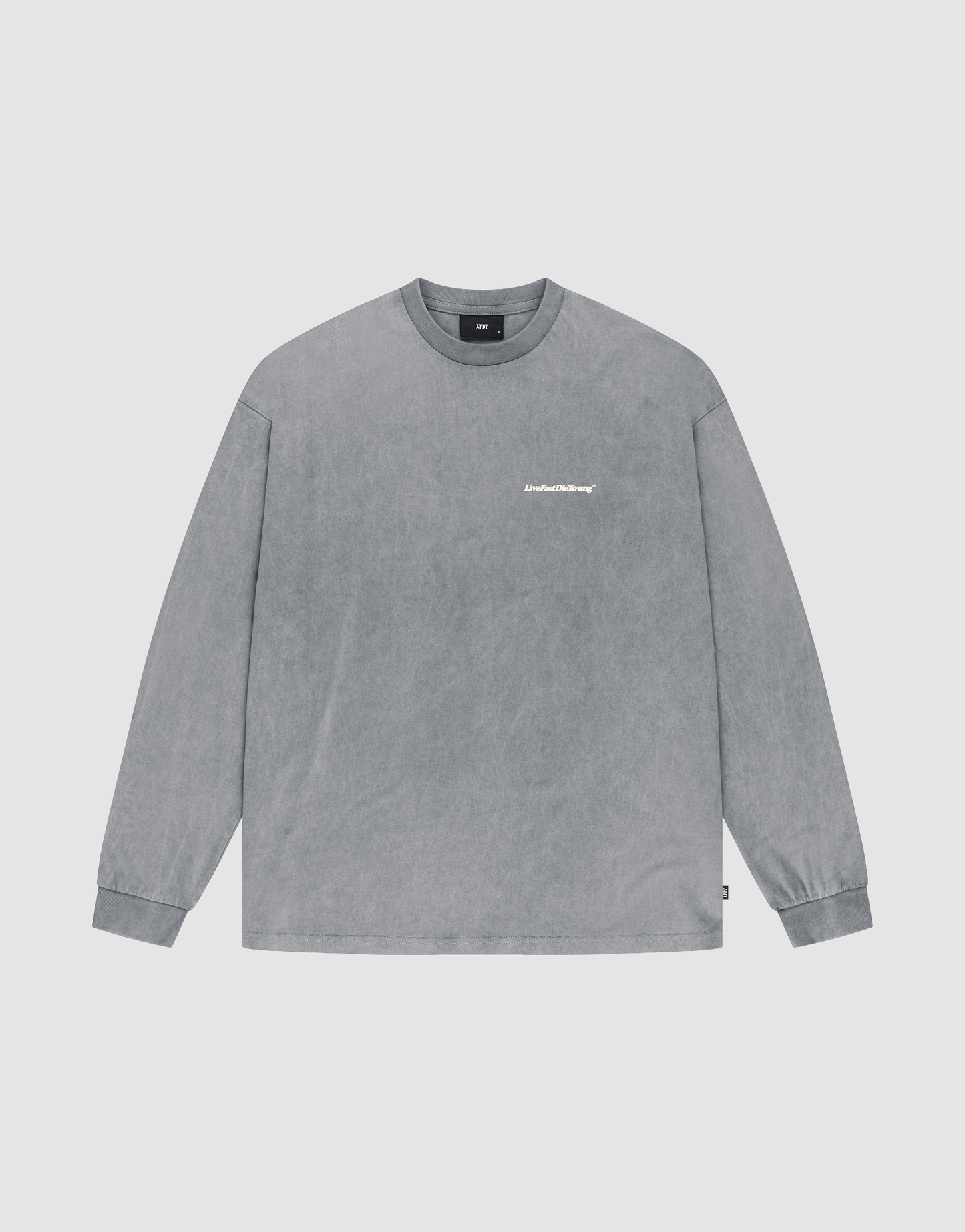 The Basic Longsleeve by LIVE FAST DIE YOUNG is a gray, oversize fit crewneck with long sleeves, ribbed cuffs, a washed texture, and small white logo on the chest. Made from 100% Baumwolle and shown on a plain light background. | plain