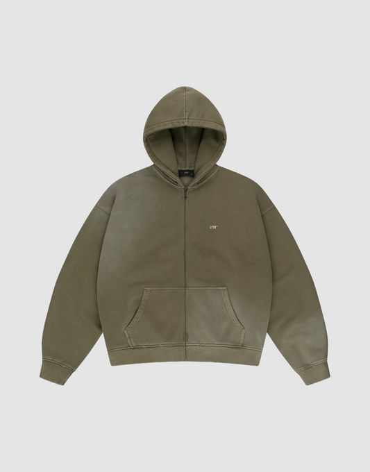 The LIVE FAST DIE YOUNG Basic Hooded Zip is an olive green oversized zip-up hoodie with a hood, front pouch pockets, and a subtle “LIFE” logo on the left chest, shown laid flat on a plain light gray background. | plain