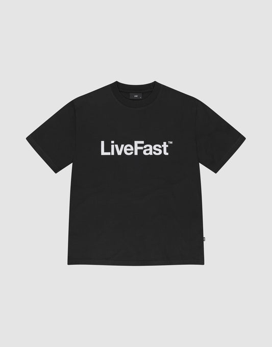 The Basic LiveFast Tee by LIVE FAST DIE YOUNG is a black regular fit T-shirt with a bold "LiveFast™" front print, made from 100% Baumwolle, shown on a plain light gray background. | plain