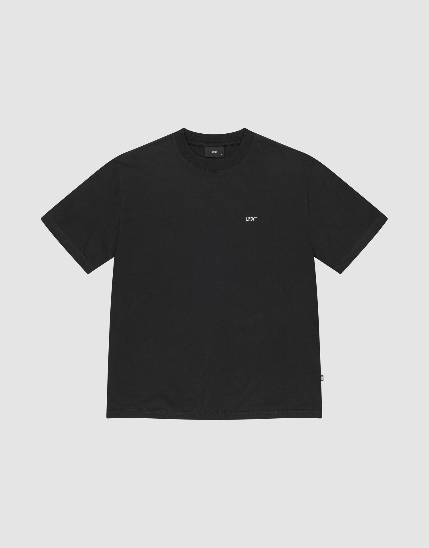 The Basic Chest Tee by LIVE FAST DIE YOUNG is a plain black regular fit, short-sleeve t-shirt in 100% cotton, featuring a small white LIFT logo below the collar. The shirt is displayed flat on a light gray background. | plain